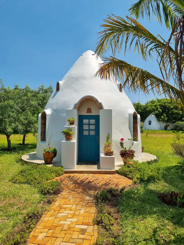 Unique dome-style accommodation at Humbi Farm in Mozambique, featuring rounded architectural structures set within a natural landscape, blending sustainable design with a tropical retreat environment.