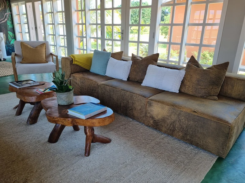Stylish, serene interior of Humbi Farm in Mozambique, perfect for a meditation and yoga retreat, featuring natural textures, soft lighting, and open, calming spaces that blend with the tropical surroundings